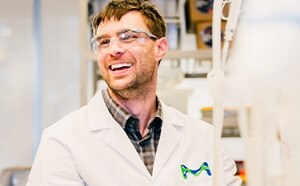 Scientist smiling in a lab