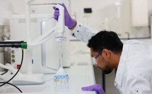 A reseacher uses a Milli-Q to dispense water for an experiment. 