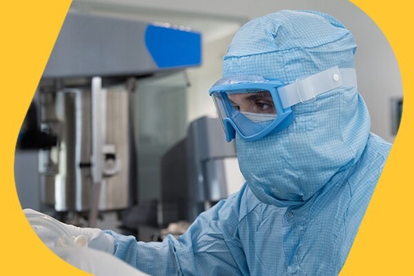 Operator pushing mRNA drug substance bag into freezing trays