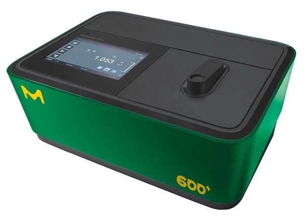 Spectroquant® spectrophotometer Prove 600 plus. The device has a sleek, modern design with a rectangular body. It is green with a black top and features a touchscreen interface displaying measurement data, as well as a slot for sample insertion and the "M" logo.