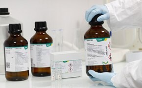 Three titration reagent bottles on a laboratory bench